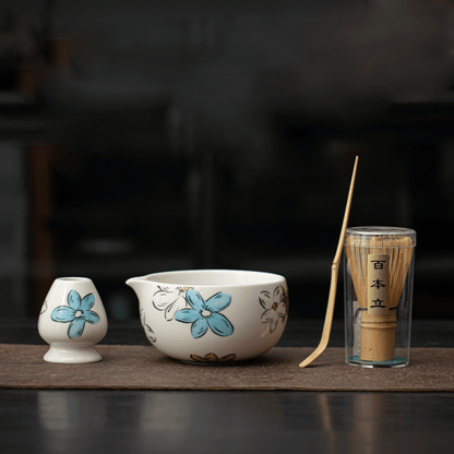Ceramic tea set with floral design on a dark background