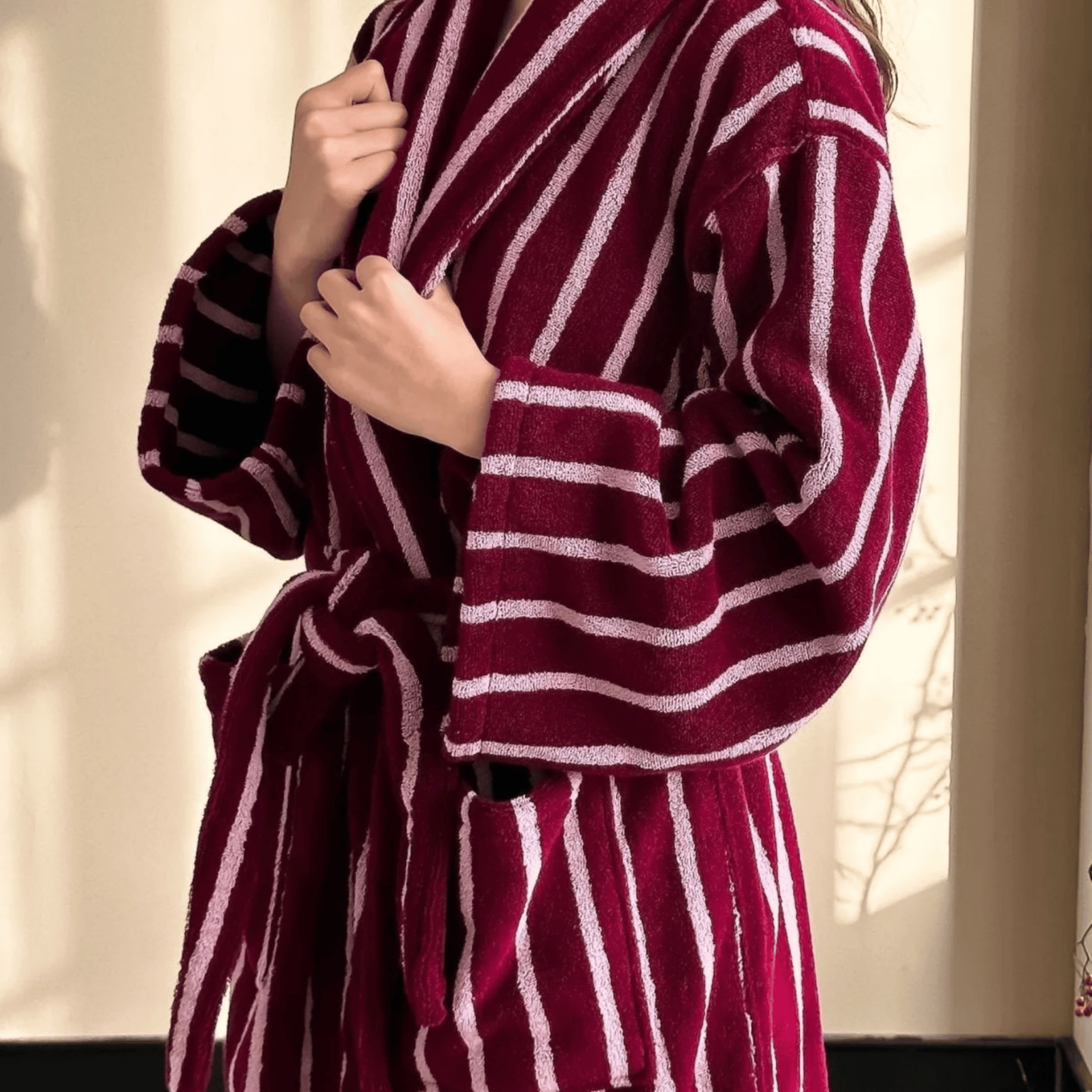 Maroon and white striped robe being worn by a person.