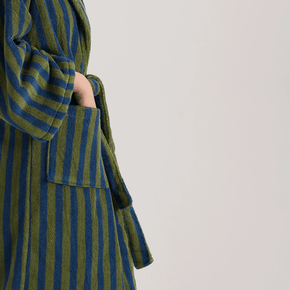 Green and blue striped coat on a plain background