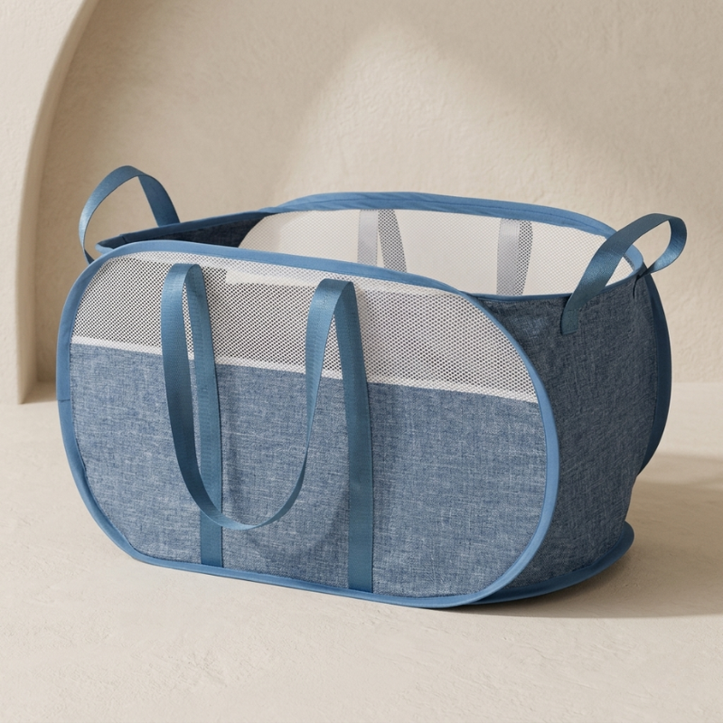 Blue mesh laundry basket on a beige background