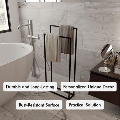 Modern bathroom featuring a black freestanding towel holder with two hanging towels, placed next to a white bathtub. The marble wall tiles and decor elements, like a mirror and countertop accessories, highlight its elegance.