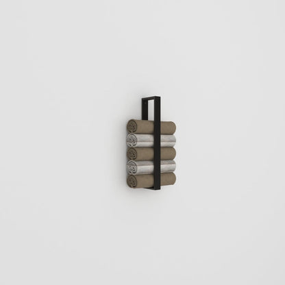 A sleek black towel holder mounted on a plain white wall, neatly stacked with rolled towels in neutral tones, showcasing its simple and functional design.